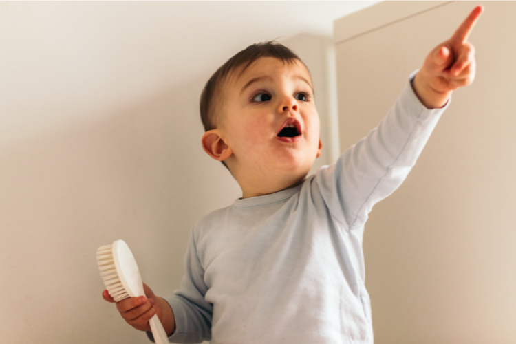 Child pointing at a far object during a near and far focus game to support visual attention and focusing skills
