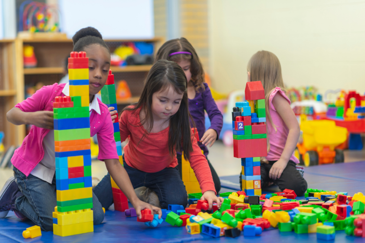 Children building with blocks to practice hand-eye coordination at school