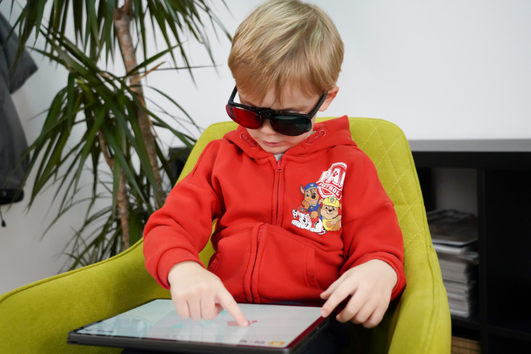 Child using AmblyoPlay vision therapy games at home on a tablet
