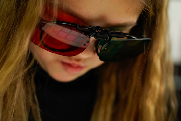 Child wearing red-green glasses used for binocular vision therapy exercises